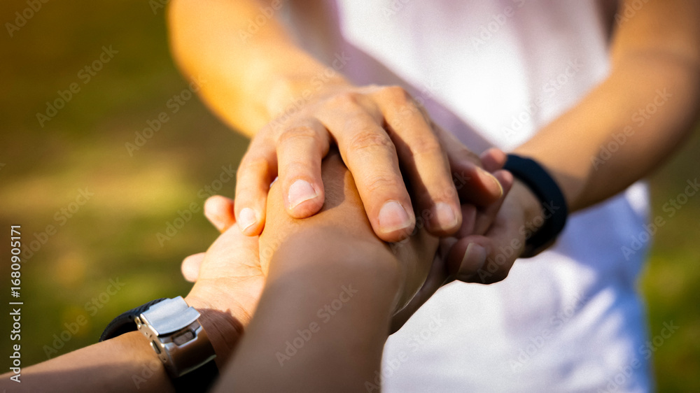 Fototapeta premium Man hand as lending a helping hand as trust together with compassion concept as lens flare scene at park