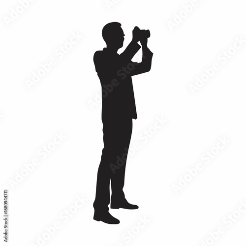 a man taking photos with binoculars standing upright