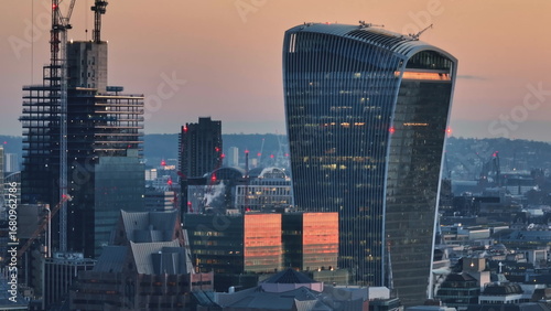 Photography United Kingdom, London: Aerial view capturing the London skyline at sunset, highlighting the iconic Walkie-Talkie building amidst modern urban architecture