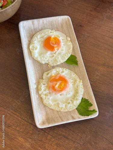 Two Fried Eggs on a Wooden Plate