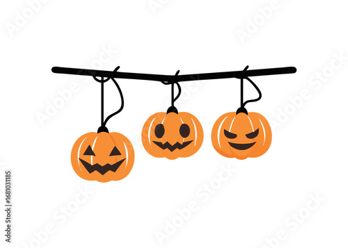 Three carved pumpkins hanging on a wire for Halloween decoration