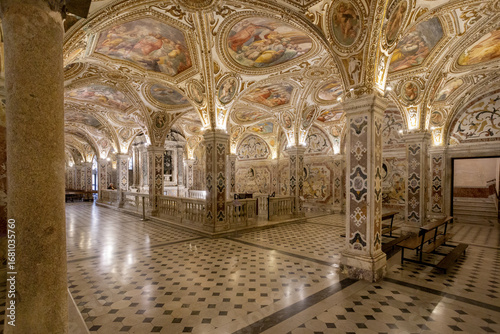 Salerno, Italy - 07 May 2025: View of the Saint Matthew crypt ornate columns reaching towards the frescoed ceilings, a symphony of light and shadow dancing on the marble floor.