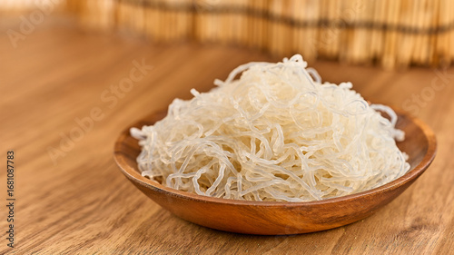 closeup Korean glass noodle vermicelli for Japchae food in wood bowl on wooden table food background with copy space