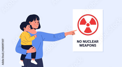 Woman with child pointing at a nuclear weapons warning sign.