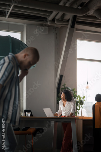Wallpaper Mural Concentrated female entrepreneur using laptop while working in office Torontodigital.ca