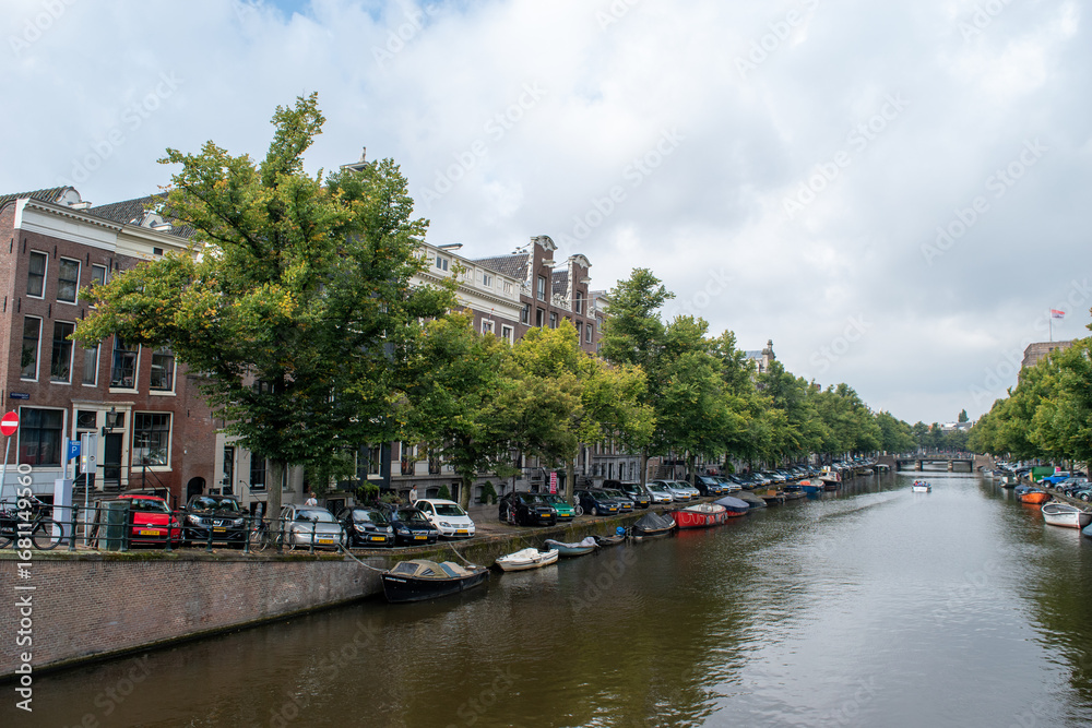 Fototapeta premium Beautiful cityscape view of the city of Amsterdam as seen from the canal and bridges.