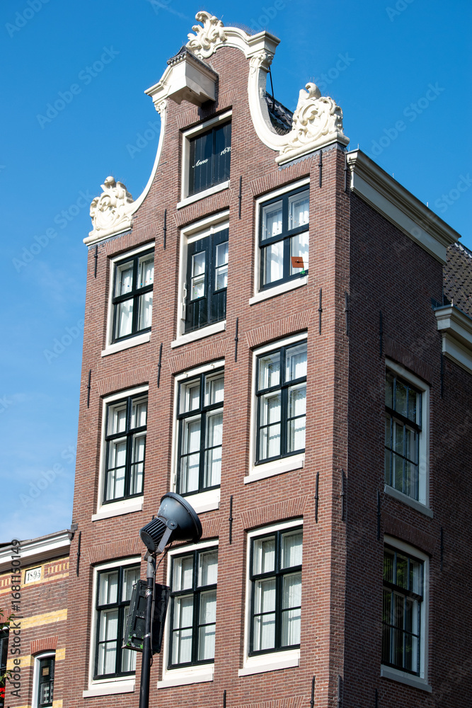 Fototapeta premium Beautiful cityscape view of the city of Amsterdam as seen from the canal and bridges.