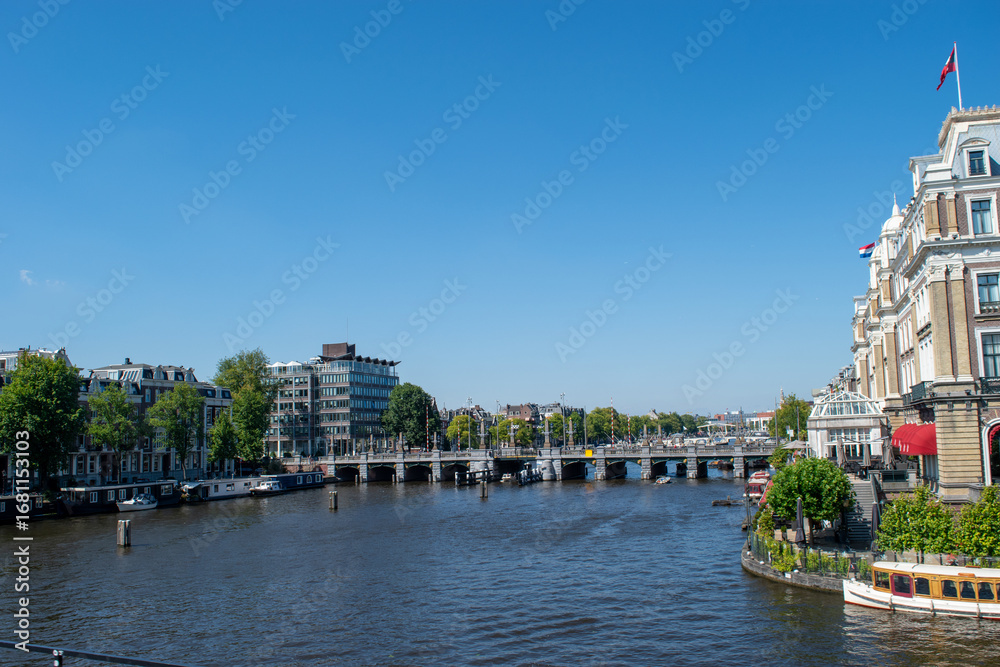 Naklejka premium Beautiful cityscape view of the city of Amsterdam as seen from the canal and bridges.