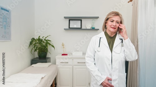Mature Female Doctor Engaged in a Professional Phone Consultation, Providing Medical Advice
