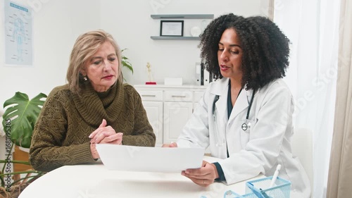 A Diverse Female Doctor Consults With Her Mature Female Patient About Health and Wellness