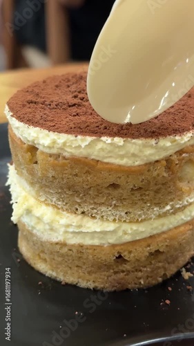 enjoy breaking off a piece of tiramisu in a coffee shop on a black round plate delicious coffee dessert calories delicacy