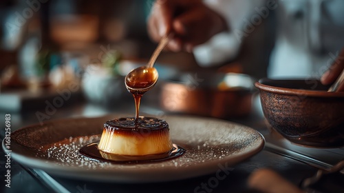 Chef spoons caramel over flan on a plate, gourmet dessert. Showcases food preparation, dining, or restaurant concepts.