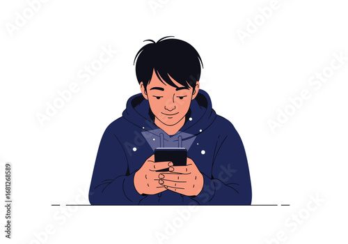 Young man engrossed in his mobile phone with a relaxed and focused expression wearing a blue hoodie