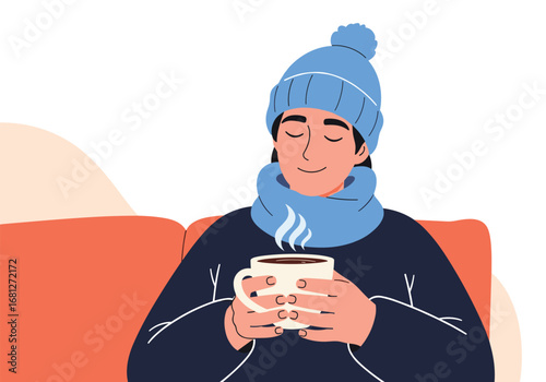 Young person enjoying warm beverage cozy winter clothing resting comfortably indoors
