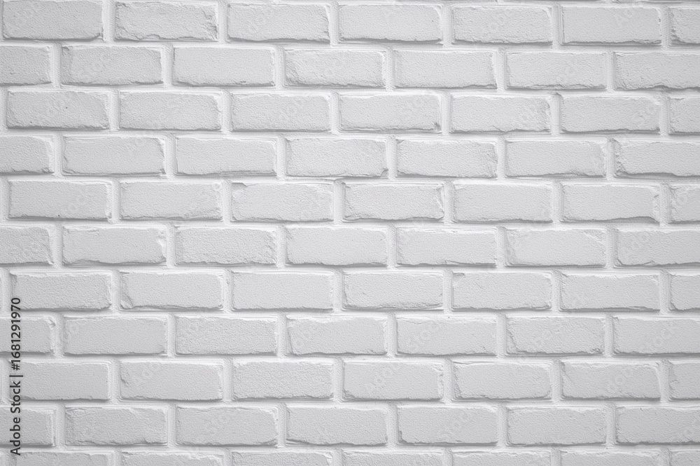 Naklejka premium Gypsum plaster decorative bricks painted grey on a white wall background