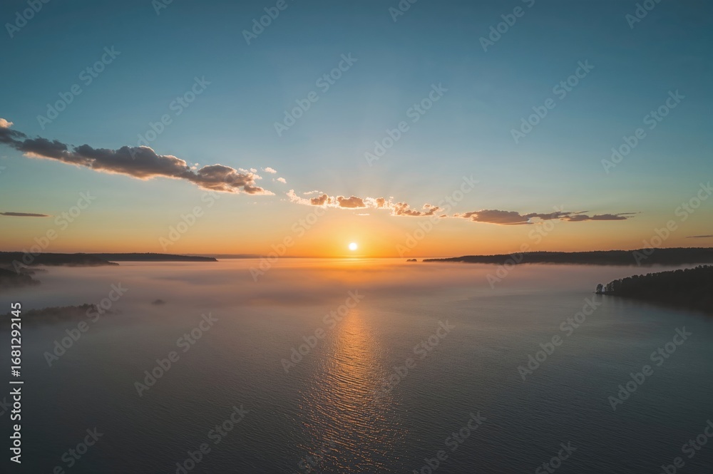 Fototapeta premium Early dawn with foggy landscape enhancing the lake's charm