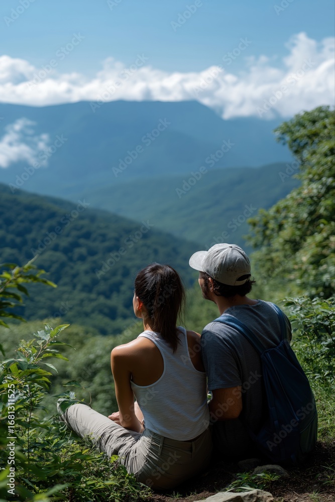 Naklejka premium Young asian couple enjoying scenic mountain view in serene landscape