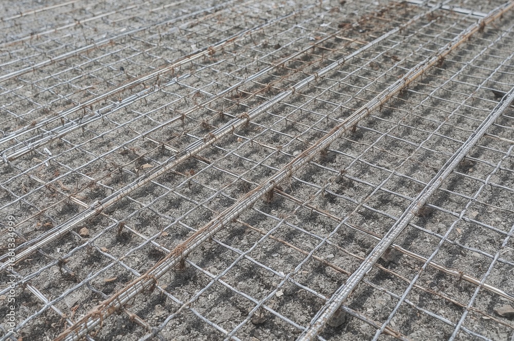 Fototapeta premium Steel reinforcement grid placed on decking, prepared for concrete casting.