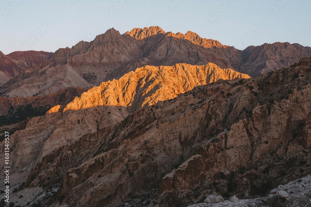 Fototapeta premium Rugged Arid Peaks Highlighted by Patches of Light and Shadow