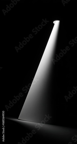 A single spotlight illuminates a dark space