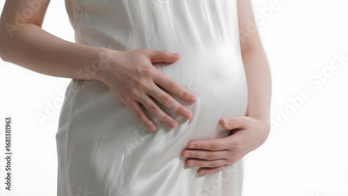 Wallpaper Mural Close-up of a pregnant woman in a silky white dress, gently touching her belly.
 Torontodigital.ca