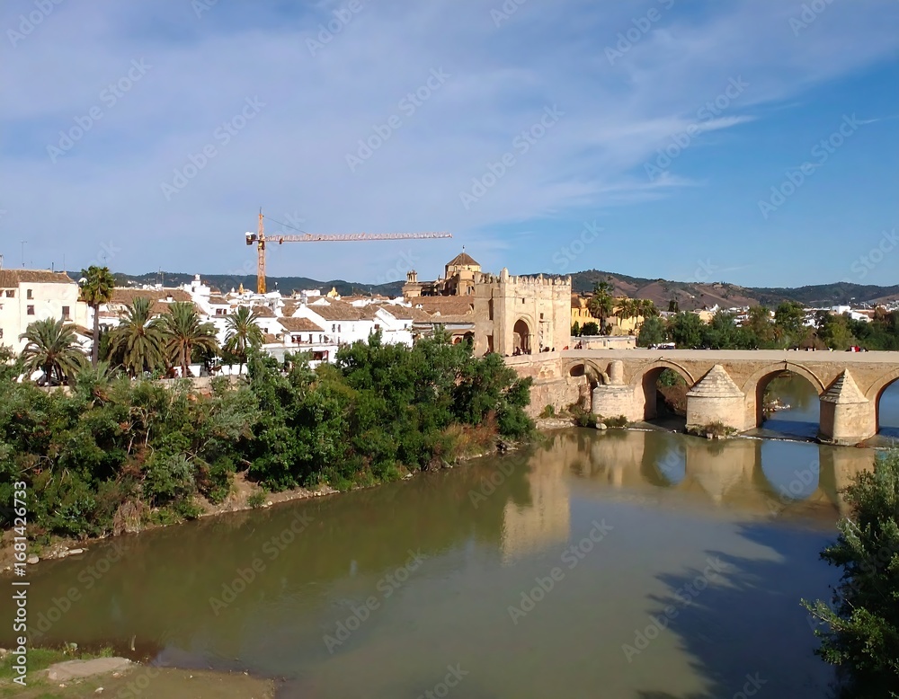Fototapeta premium Panoramic view of a Spanish city with a river and bridge