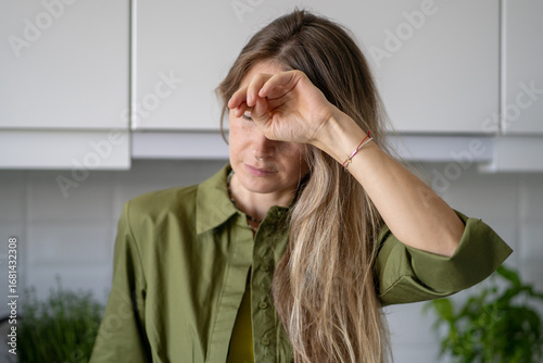 Papier peint Weak tired woman covering face at home, feeling sudden illness with nausea and near fainting condition