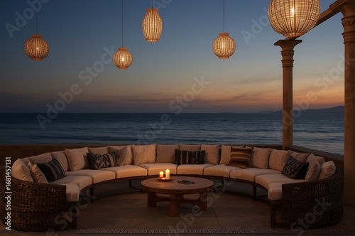 Elegant curved outdoor seating area with moroccan style lanterns and candles on a beach at sunset with ocean view