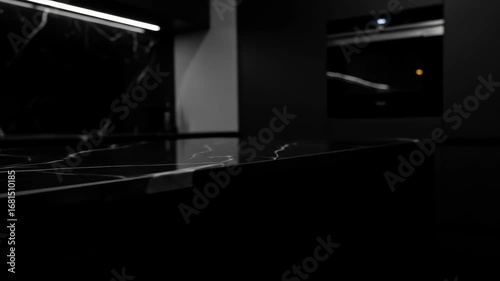 Close-up of black marble countertop with white veins in a modern kitchen interior, showcasing the countertop, modern design, and luxury.