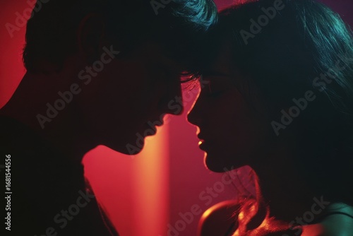 Silhouetted Couple in Romantic Embrace, Red Lighting.
