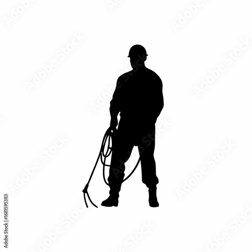 Silhouette of a worker installing cable into underground conduit