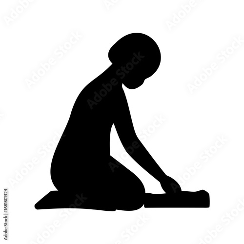 Silhouette of a person kneeling and working or interacting with object below
