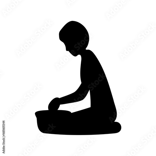 Black silhouette of a person kneeling and working in a bowl with hands