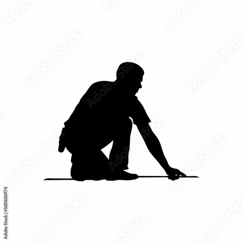 Silhouette of worker installing cable in trench