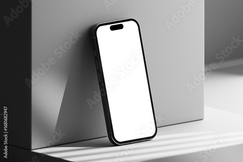 Modern smartphone mockup leaning on minimalist block for clean UI/UX app presentation.