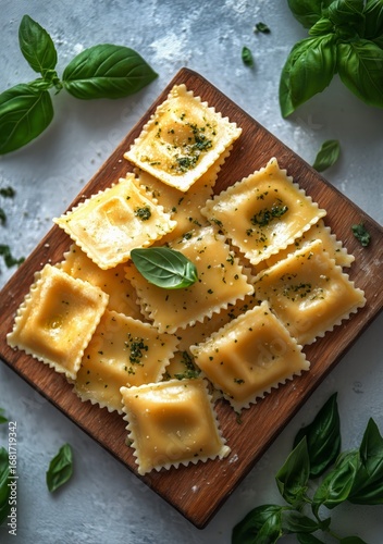 Homemade Ravioli Prepared on a Wooden Cutting Board With Fresh Basil Leaves a...