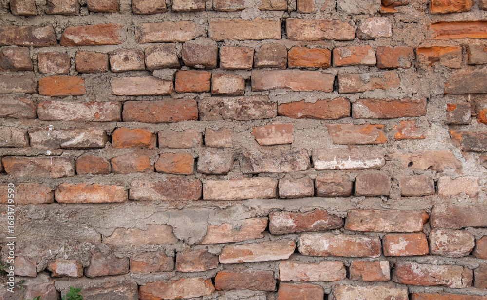 Obraz premium old and worn brick wall without plaster.