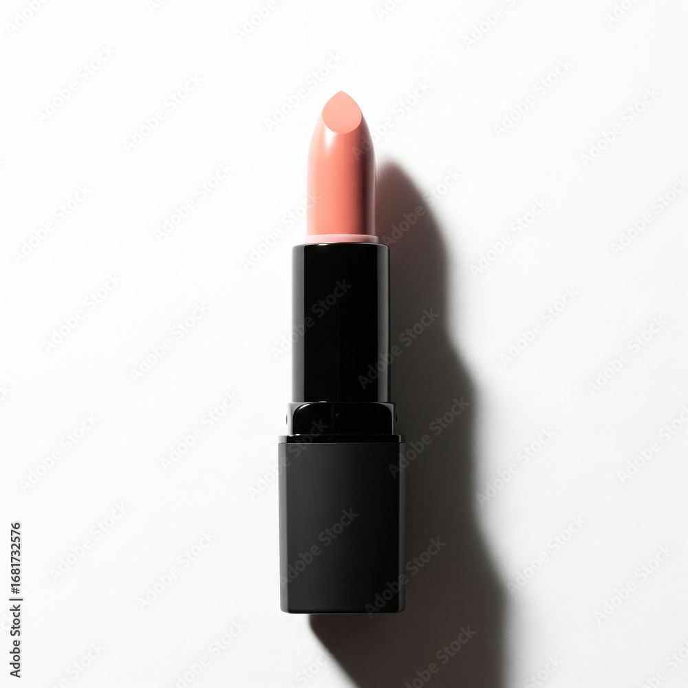 Obraz premium lipstick isolated on white background. Nude pink lipstick in a black tube lying horizontally on a white background.