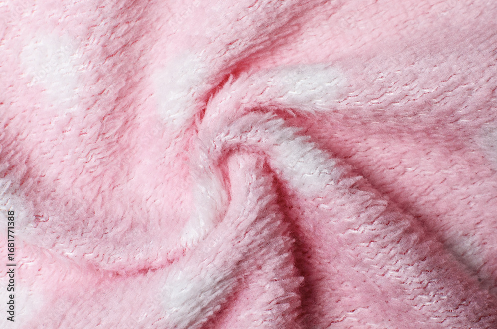 Fototapeta premium Soft light pink wool fabric twisted into spiral shape creating textured textile background for cozy fashion and decorative design concepts
