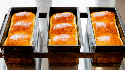 Golden brioche loaves glisten like sunlit amber, perfect for Lammas Day or National Baking Week's doughy delight fiestas