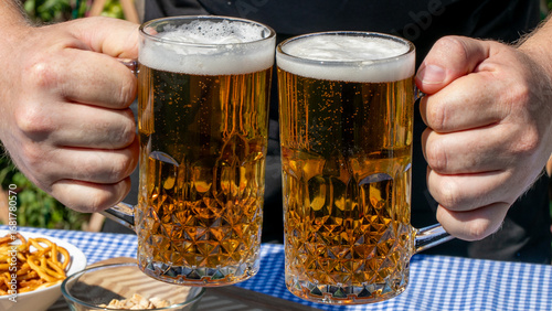 Two frothy mugs clink in jubilant camaraderie, embodying the Oktoberfest spirit and the quirky charm of beer-tasting rituals