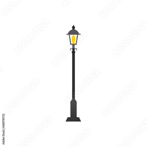 a dark grey  ornate street lamp stands tall agains