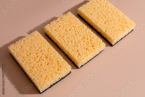 Golden sponges rest in contemplative alignment, evoking Clean Up Day fervor and minimalist tidiness, celebrating Hygge harmony