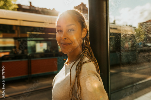 Sunlight shining on smiling beautiful young woman with braided hair