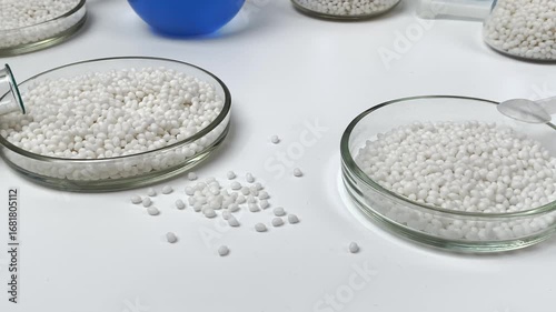 Close-up of a petri dish for chemical experiments against the background of other laboratory glassware. Selective focus.