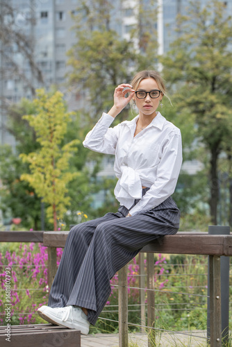 Business woman, full body portrait of a blonde girl in white shirt
