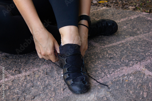 Lacing laces shoes for Irish dance on the floor