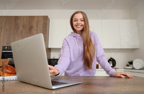 Young woman using modern la...