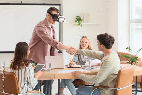 Young man in VR glasses wit...
