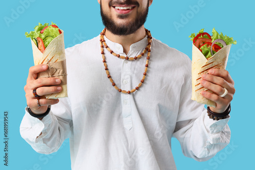 Young Muslim man with tasty...